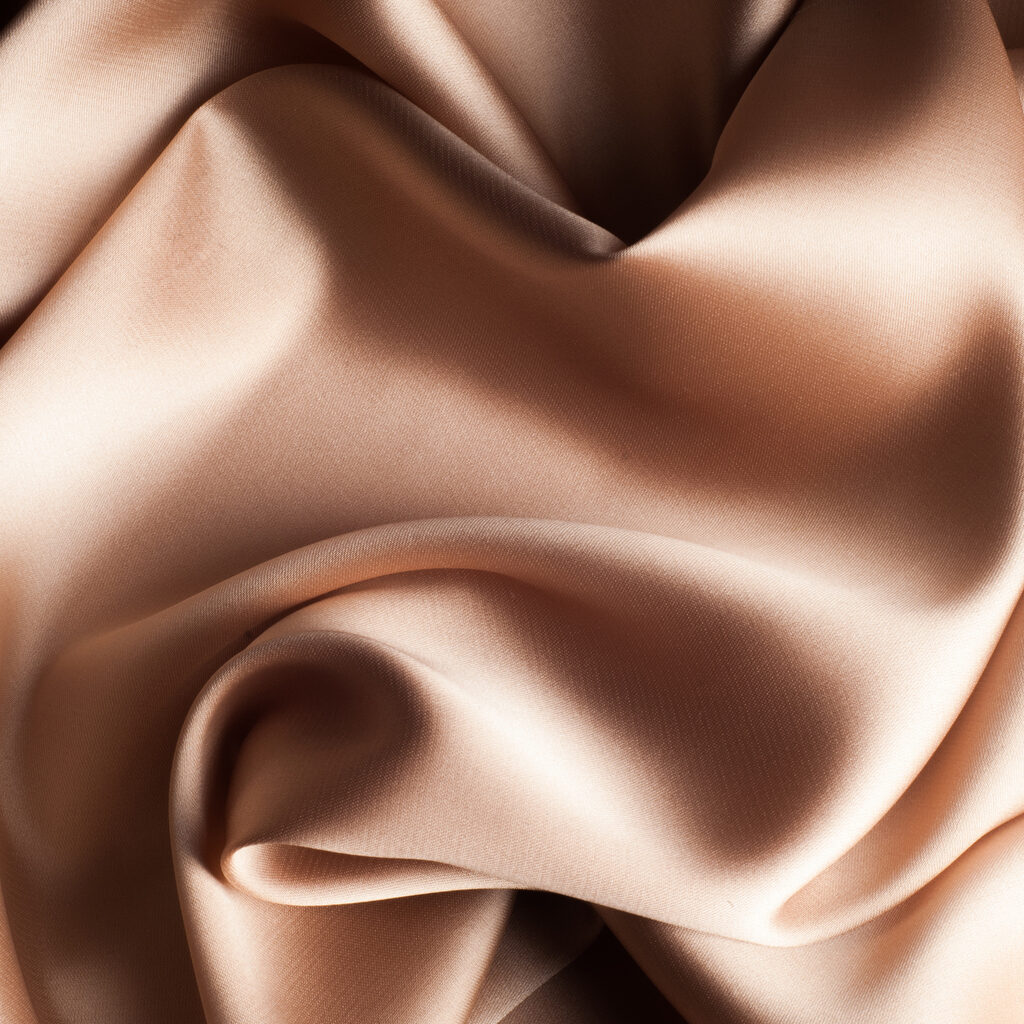 tissue, textile, cloth, fabric, material, texture. beige color. cloth, typically produced by weaving or knitting textile fibers.