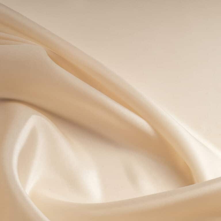 tissue, textile, cloth, fabric, material, texture. beige color. cloth, typically produced by weaving or knitting textile fibers.