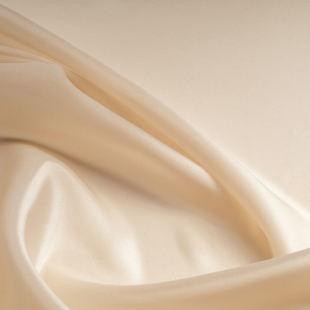tissue, textile, cloth, fabric, material, texture. beige color. cloth, typically produced by weaving or knitting textile fibers.