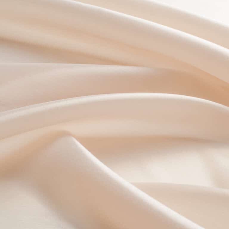 tissue, textile, cloth, fabric, material, texture. beige color. cloth, typically produced by weaving or knitting textile fibers.