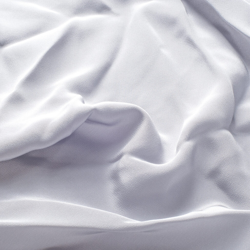 texture lace. a fine open fabric, typically one of cotton or silk, made by looping, twisting, or knitting thread in patterns and used especially for trimming garments.