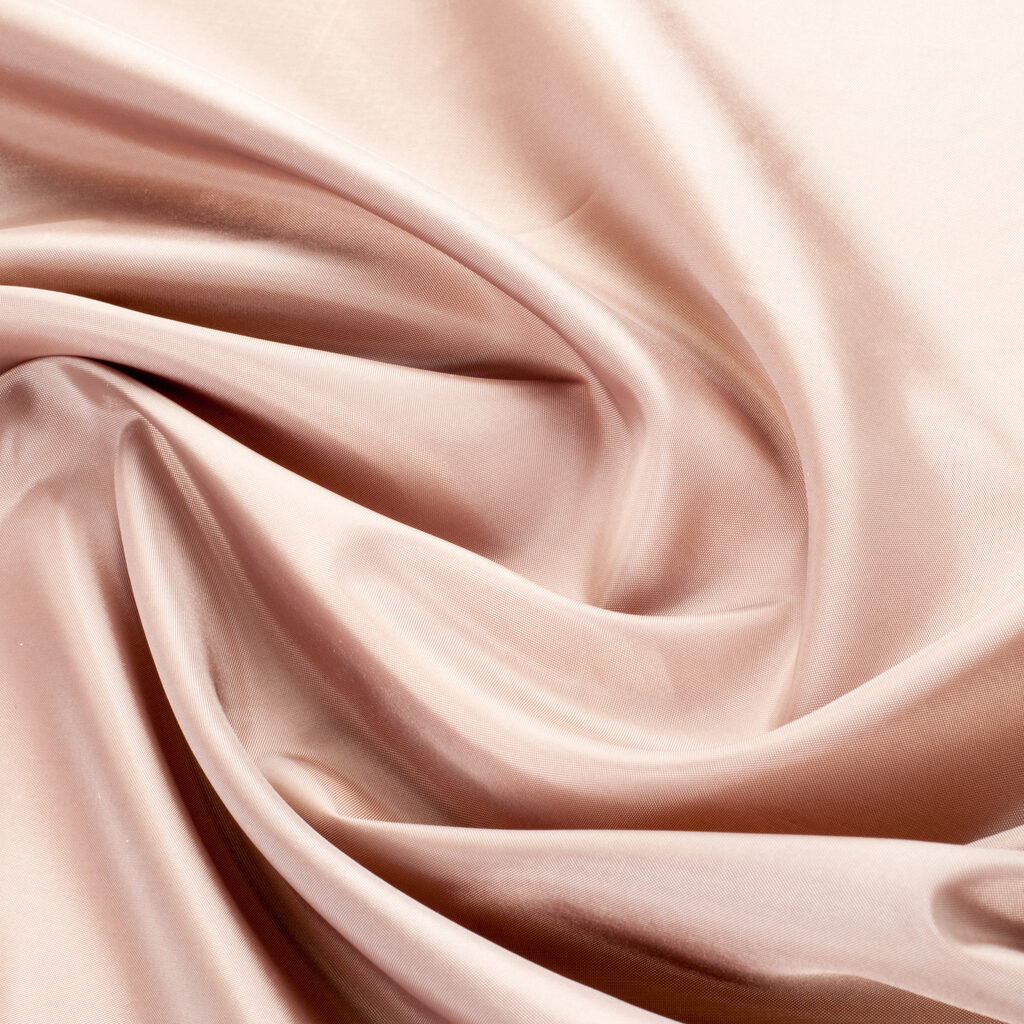 texture lace. a fine open fabric, typically one of cotton or silk, made by looping, twisting, or knitting thread in patterns and used especially for trimming garments.