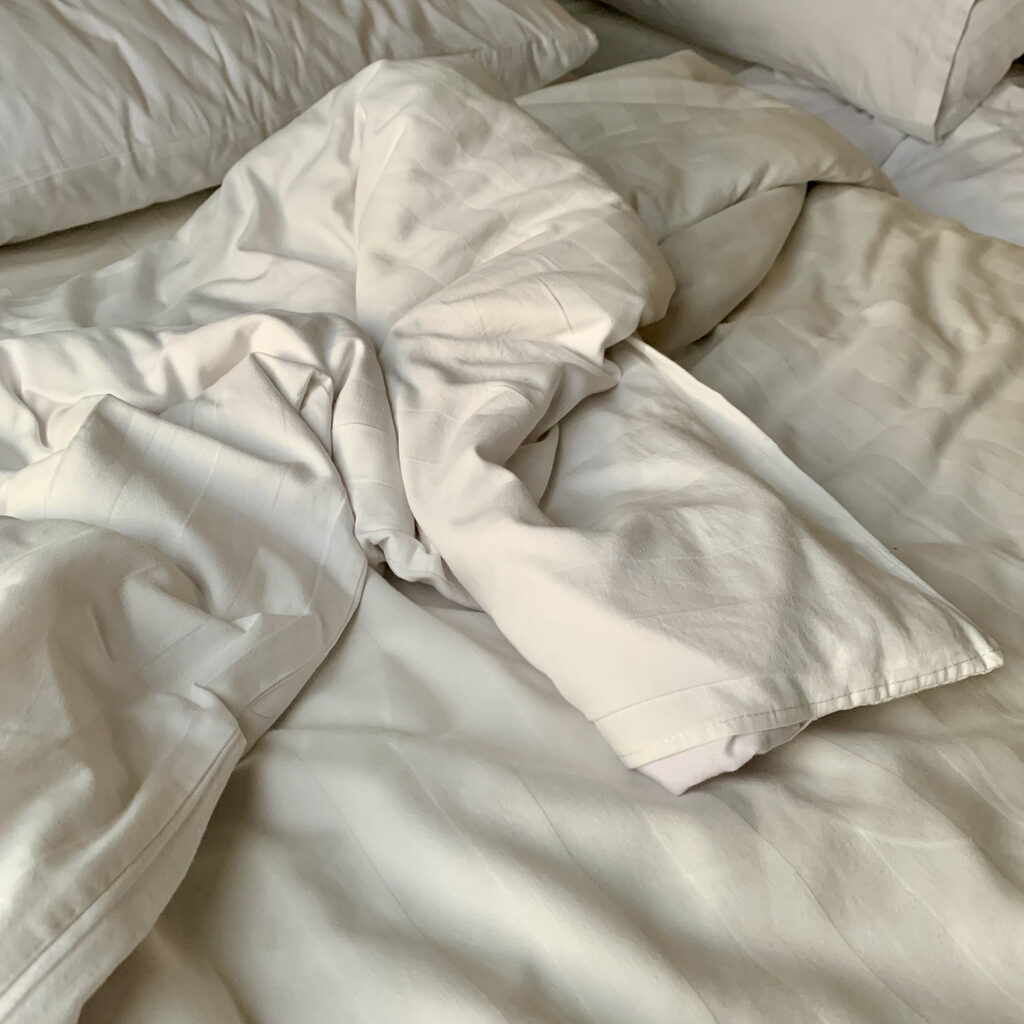Messy wrinkled white blanket