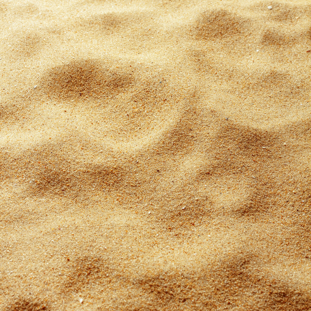closeup of sand pattern of a beach in the summer