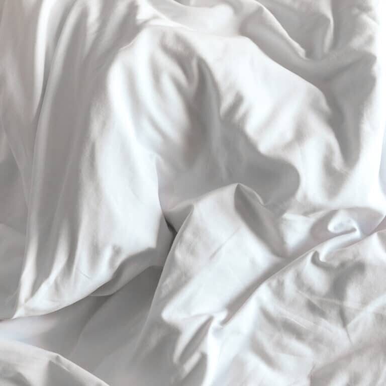 Top view of white bedding sheets after wake up in the morning